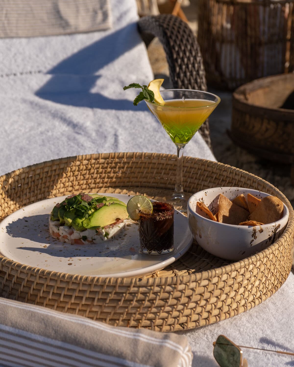 A wicker tray with breakfast and a cocktail, just served at the Baja house