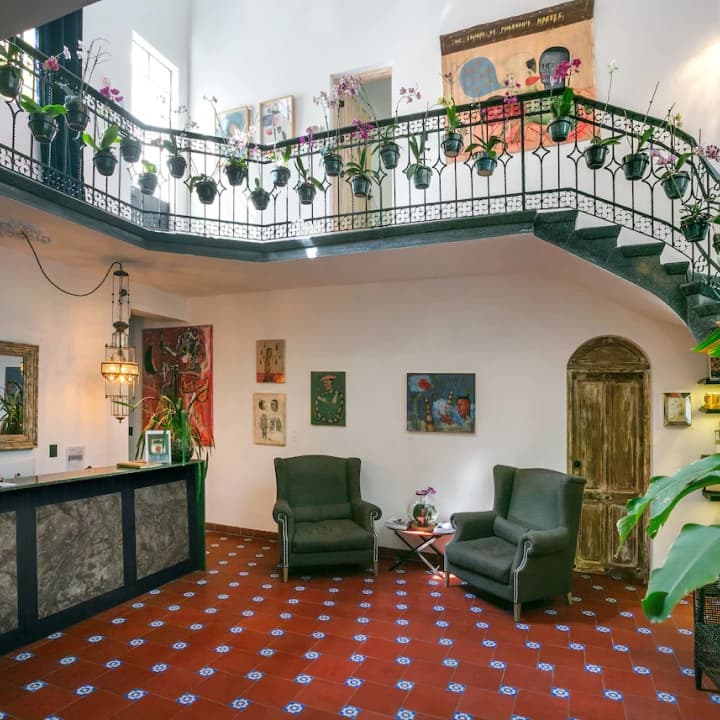 The Polanco lobby: the staircase with hanging orchids and Mexican folk art on the walls